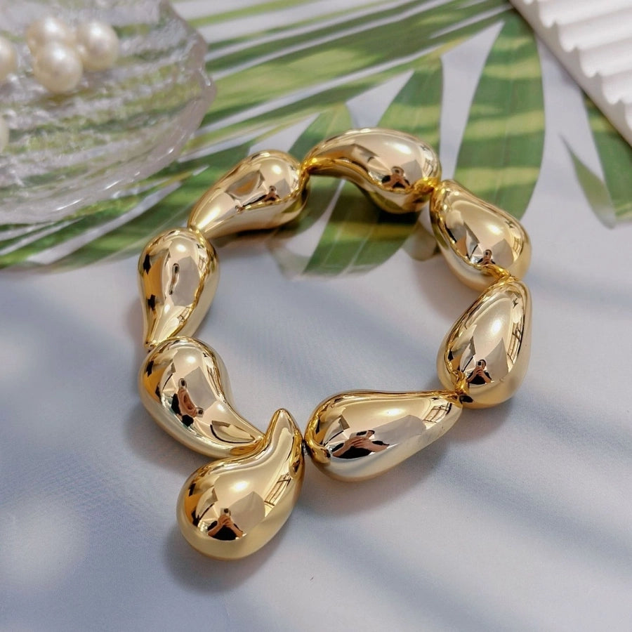 Pulsera Asimétrica de Cobre con Diseño de Globo y Motivo de Gotas de Agua en Forma de Rombos